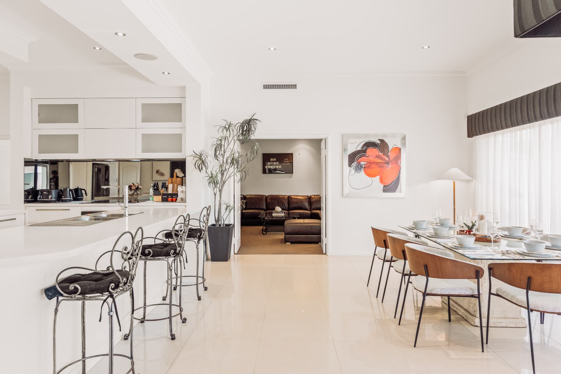 White kitchen with breakfast bar and formal dining setting