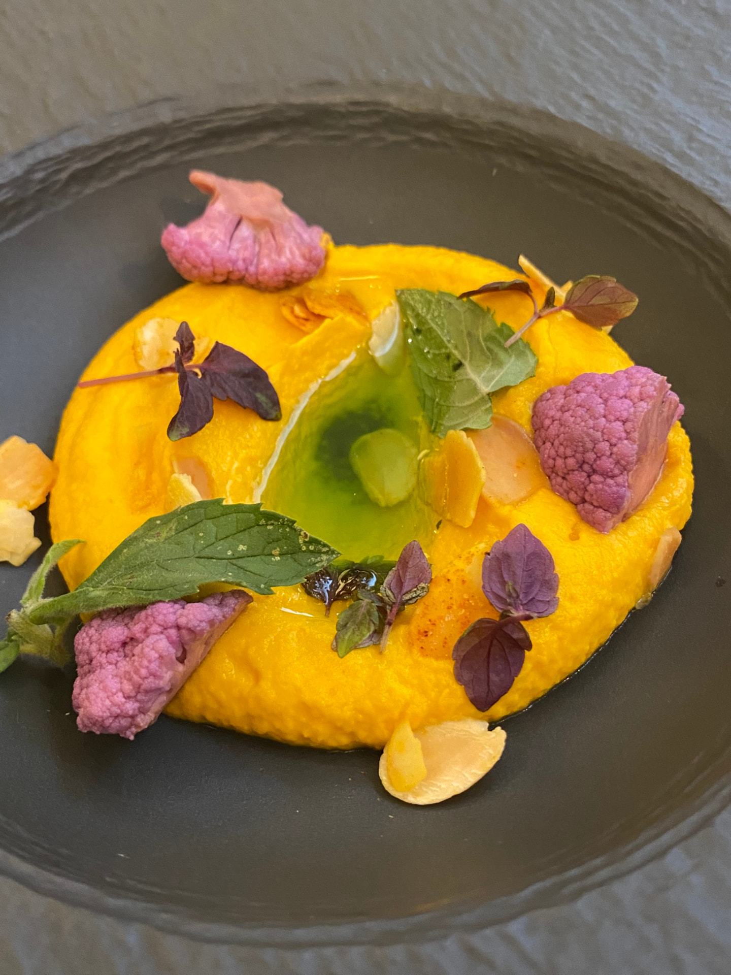 Roast carrot purée with almonds, cauliflower and herb oil