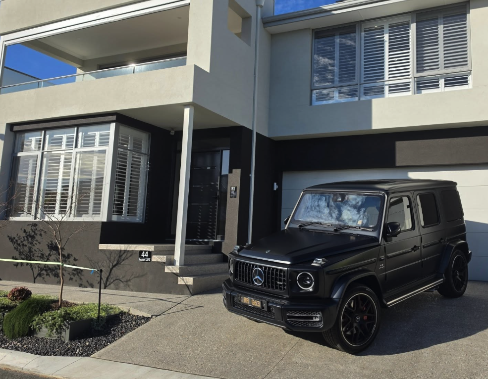 Matte black Mercedes-AMG G 63 parked at the entrance of a Mirage Stays residence